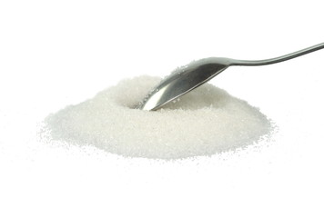 Heap of granulated sugar in a spoon isolated on white background.