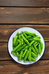 sweet peas on a wooden surface