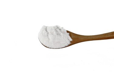 Pile of wheat flour in a wooden spoon isolated on white background.