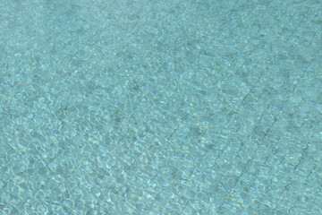 Fototapeta na wymiar Water in the swimming pool close-up. Natural abstract background