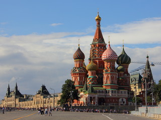 Fototapeta na wymiar Russia, St. Basil's Cathedral on the background of the Central store GUM on red square on a summer day against the blue cloudy sky, the sights of Moscow