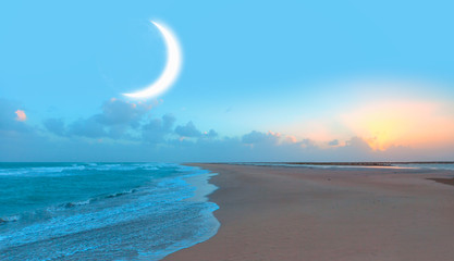 Crescent moon rising above calm sea in sunset sky "Elements of this image furnished by NASA" © muratart