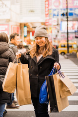 Young woman shopping at mall in Japan, Asian woman with shopping bag,Travel concept and shopping concept, vintage tone,
