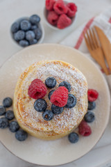 home made sweet vanilla pancakes with berries on a table