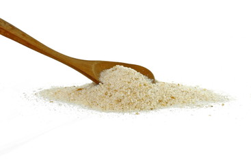 Pile of breadcrumbs in a wooden spoon isolated on white background
