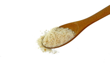 Pile of breadcrumbs in a wooden spoon isolated on white background