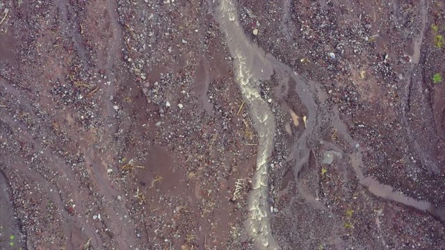 Aerial: River and rocks that flow from Mt Agung in Bali, Indonesia