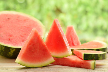 Watermelon parts or tiles without kernel by picnic in garden