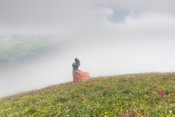Young woman looking at a mountain over a fog
