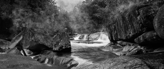 Devil's Pool or Babinda Boulders is a mystical natural pool at the confluence of three streams among a group of boulders near Babinda, Queensland, Australia. Black and White photography. -Image. © George