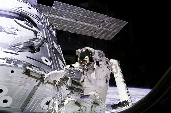 Astronauts In Spacesuits Work In Outer Space Near To Spaceship. Elements Of This Image Furnished By NASA