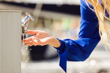 Woman washing hands outdoor