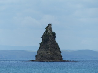 Fototapeta na wymiar strange rock island in the shape of a pyramid