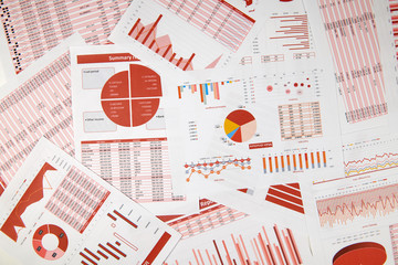 Flat top view of business workspace - reports with data, tables and analytic chart. Business...