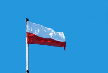 Fototapeta na wymiar Flag of Poland in blue sky.