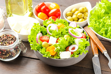 Healthy salad in bowl on wooden background. Close up