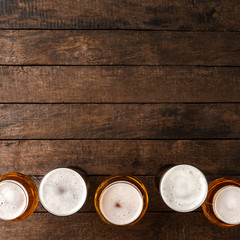 Beer glasses on wooden table with copyspace.