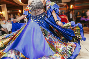 Beautiful gypsy girls dancing in traditional colorful clothing. Roma gypsy festival. Woman...