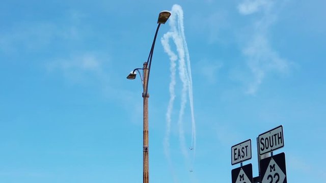 Slow motion descent of WWII era planes at summer airshow in small American city