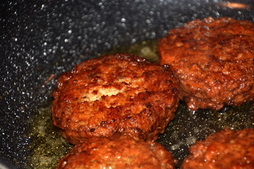 crispy meatballs fry in oil in a pan detail and macro shot, ready to eat meatloaf in a pan