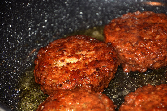 crispy meatballs fry in oil in a pan detail and macro shot, ready to eat meatloaf in a pan