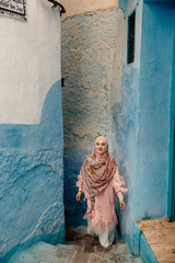 Tourist on a blue street in Chefchaouen, Morocco