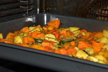 inside oven with baked oven vegetables as garnish, crispy grilled vegetarian and vegan oven vegetables seasoned with herbs and olive oil