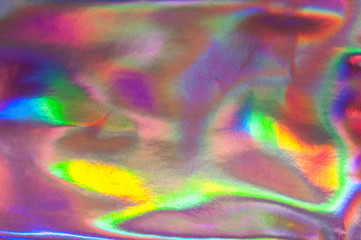 Holographic abstract colorful backdrop. Holographic color wrinkled foil. Iridescent art. Trendy...
