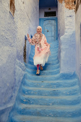 Tourist on a blue street in Chefchaouen, Morocco