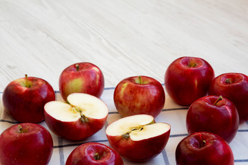 Fresh raw red apples on a white wooden background, side view. Copy space.