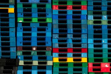 Plastic shipping pallet for sale and for rent business. Industry plastic pallet stacked at factory warehouse. Cargo and shipping business concept. Pile of plastic pallet for distribution and delivery.