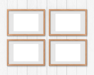 Set of 4 horizontal wooden frames mockup with a border hanging on the wall. Empty base for picture or text. 3D rendering.