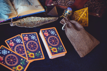 Mystical atmosphere of tarot card on the table, esoteric concept, fortune telling and predictions  - obrazy, fototapety, plakaty