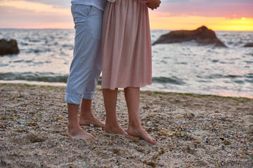 couple in love are standing and meeting sunrise at the beach in ocean shore