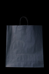 empty paper gray bag from Kraft paper, mocap, isolate, on a black background, the concept of...