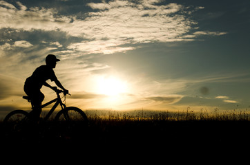 Fototapeta na wymiar cyclist silhouette at sunset, bicycle