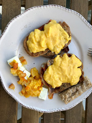 Homemade Creamy Scrambled Eggs in Breakfast Plate with Toast Bread, Cheese Cherry and Orange Jam / Marmalade.