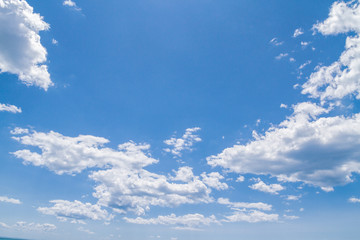 White fluffy clouds in the blue sky in summer
