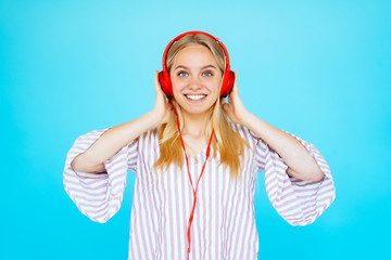 Dancing girl listens to music in earphones