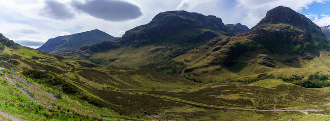 Fototapeta na wymiar Panoramic view of The Three sisters , also known as Bidean nam Bian Mountain in the Scottish Highlands in summer , Glen Coe , Scotland