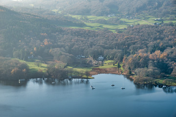 Stuning vibrant Autumn Fall landscape image of view from Gummers How down onto Derwent Wter in Lake District