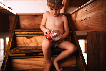 Toddler child playing with snow globe