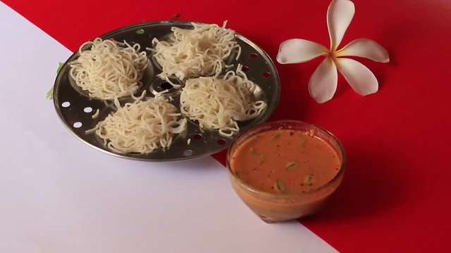 Idiyappam/ String Hoppers -Traditional Kerala Steamed Breakfast on white and red background