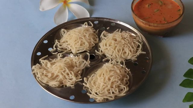 Noolappam/Idiyappam/rice noodles, popular traditional steam cooked Kerala breakfast dish with hot and spicy chickpea/lentil curry on banana leaf, Alappuzha, India. South Indian food. Noolputtu Lankan
