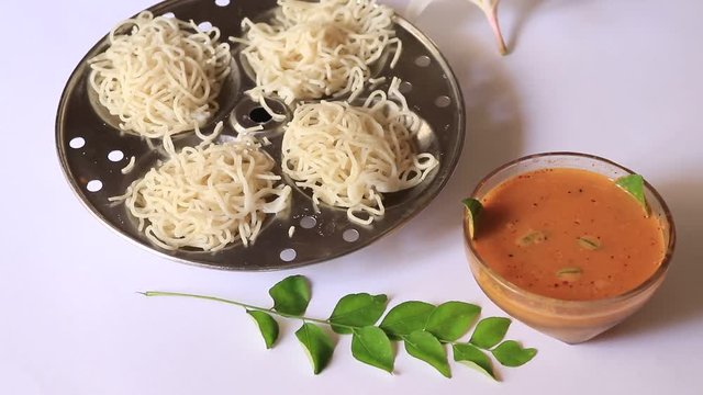Noolappam/Idiyappam/rice noodles, a popular traditional steam cooked Kerala breakfast dish with hot spicy black bengal gram curry on houseboat, Alleppey, India. South Indian food. noolputtu Sri lankan