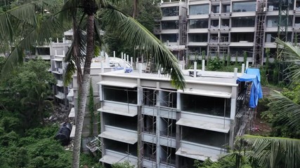 Aerial: illegal construction of hotels amongst a tropical rainforest. Ubud, Bali, Indonesia. 2 March 2019
