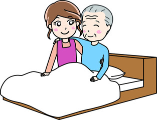 ベッドに寝ている老人男性をサポートする介護士の女性