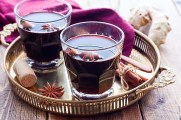 Mulled wine in glass cups on a beautiful tray, selective focus