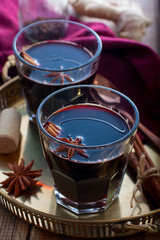 Mulled wine in glass cups on a beautiful tray, selective focus