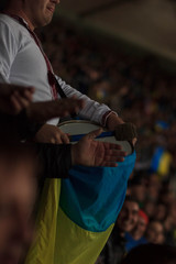 Ukrainian fan beats an Irish fan's bass drum, outside Parc Olympique Lyonnais.